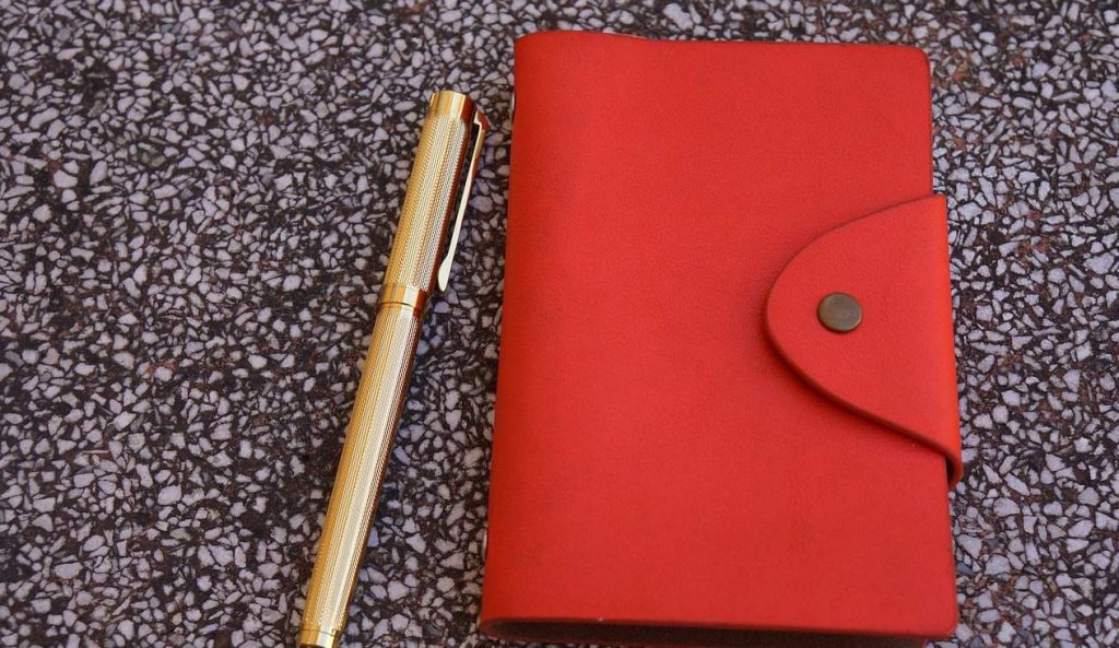 red journal and pen