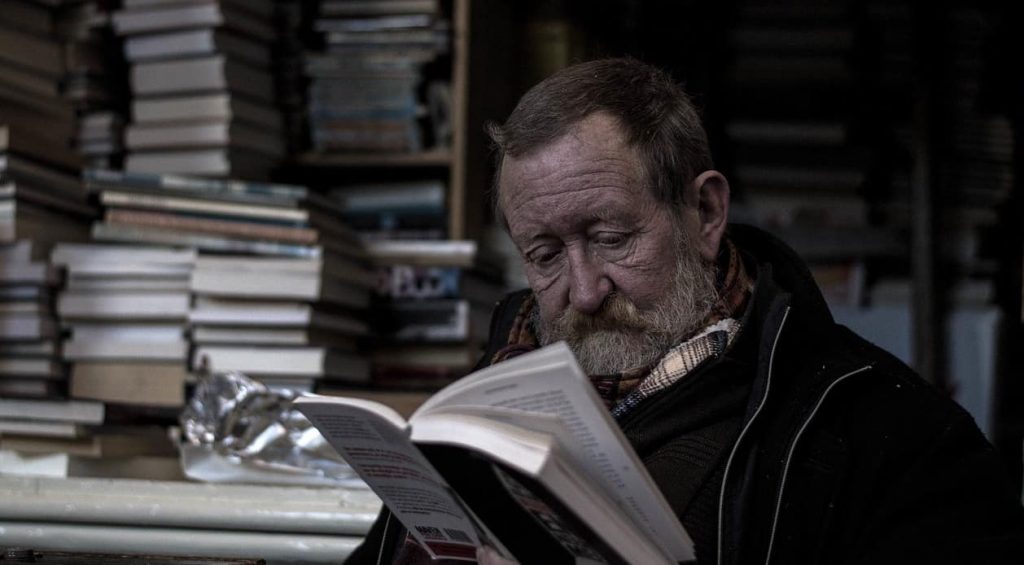 old man reading a book